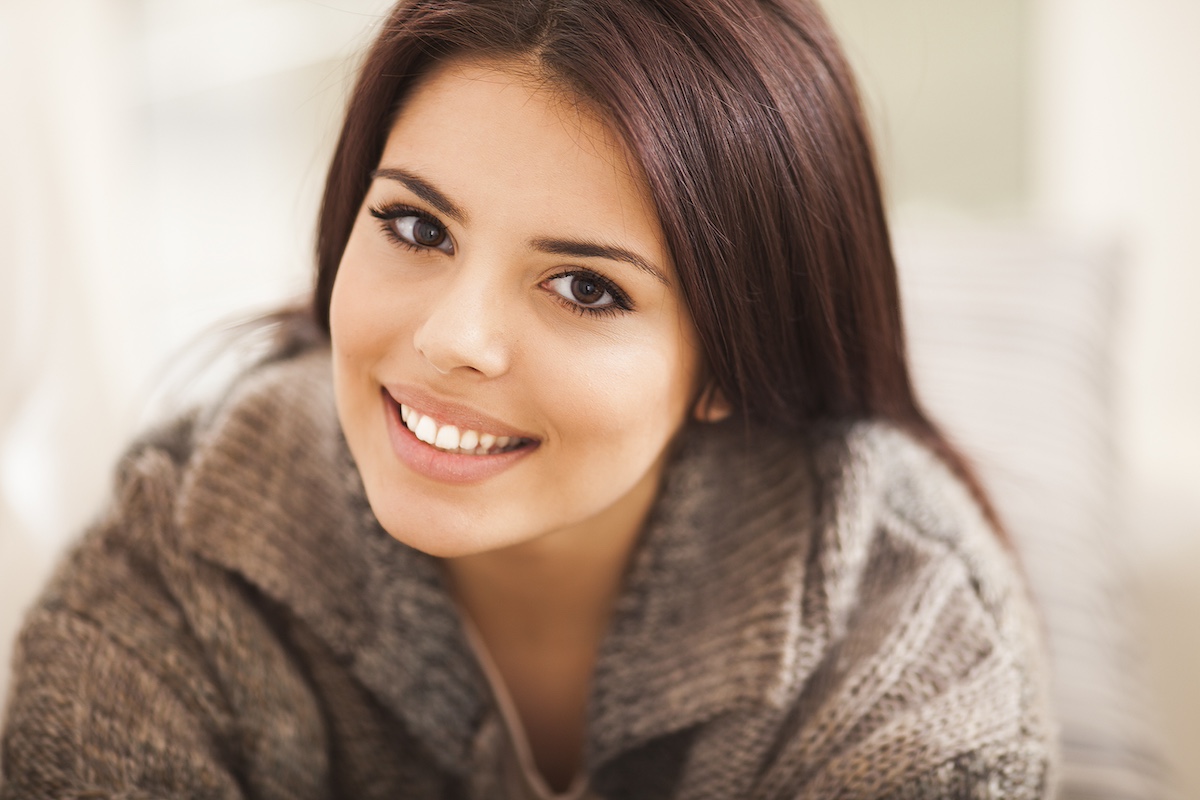 Closeup portrait of a young beautiful lady looking at camera
